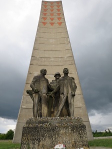 Soviet era memorial. Note that the liberating Russian comrade seems no better fed than the victims of the camp he is liberating showing that the heroic proletarian inmates of her he camp triumphed over their oppressors.
